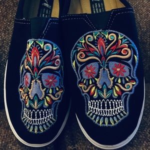 Sugar skull slip on embroidered sneakers.